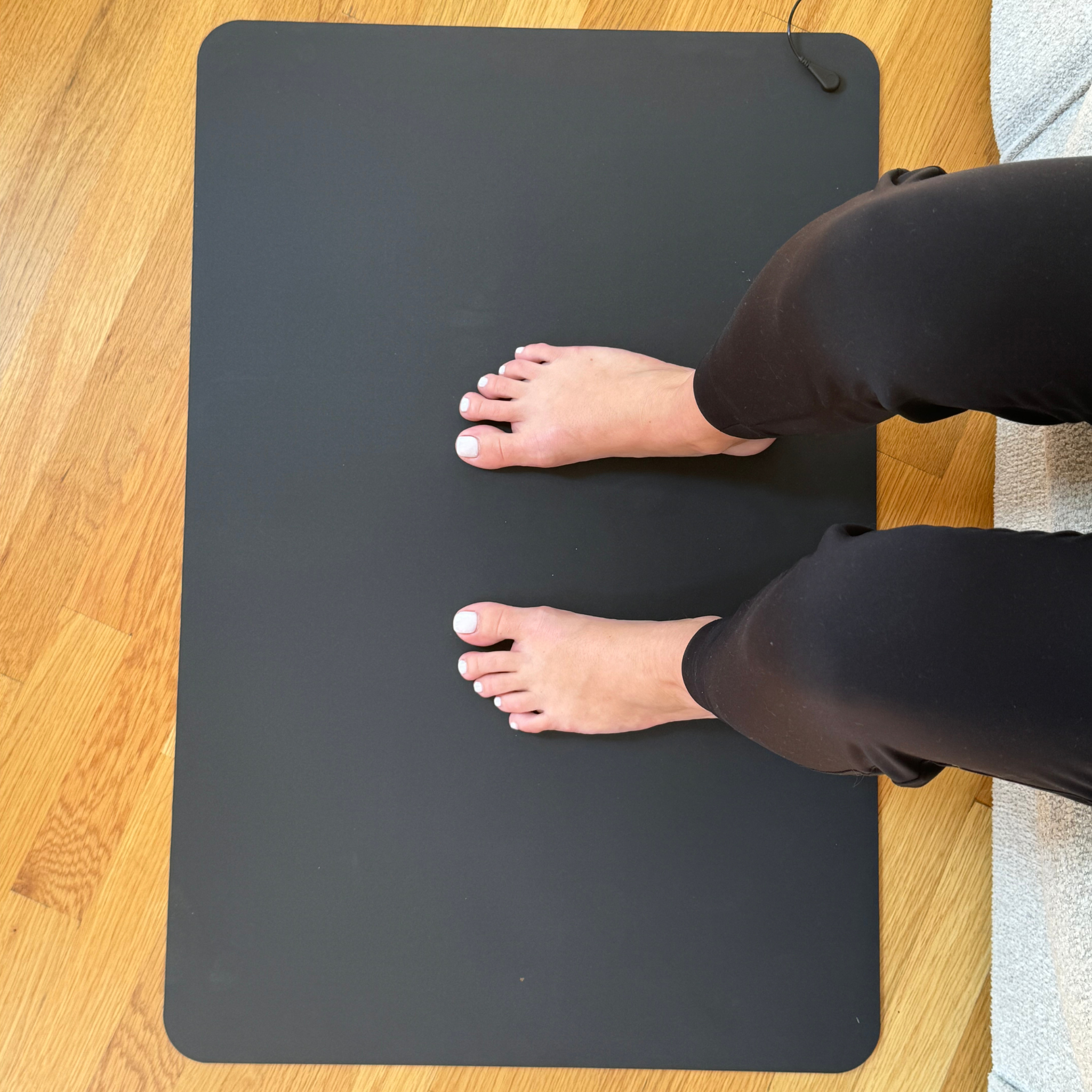 Sitting On The Earthing Floor Mat Reading 1.Png